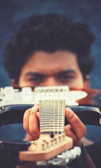 Close-up of man playing guitar