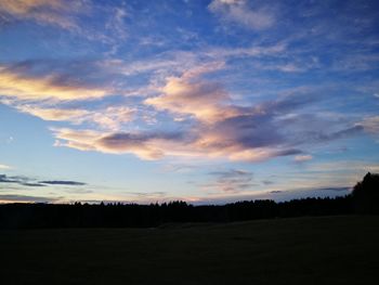 Scenic view of silhouette landscape against sky at sunset