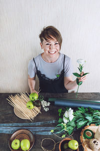 Portrait of a smiling young woman holding food