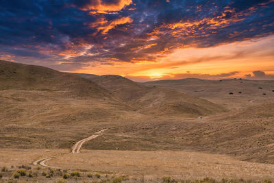 Scenic view of landscape against sky during sunset