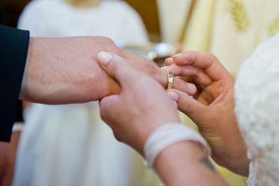 Midsection of couple holding hands