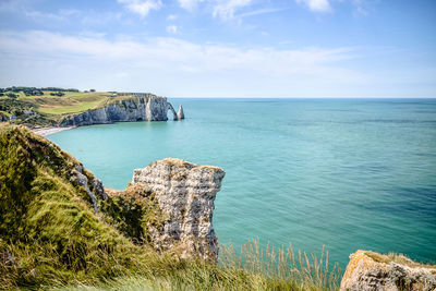 High angle view of cliff by sea at etretat