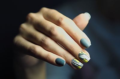 Cropped hand of woman with painted fingernails