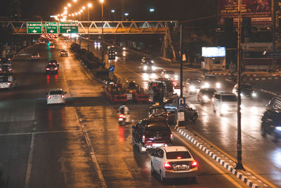 Vehicles on road in city at night