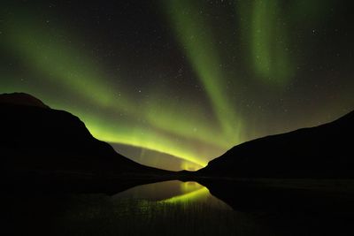 Scenic view of silhouette mountain against sky at night