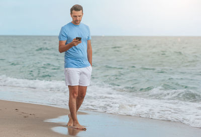 Full length of man standing at beach