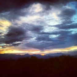 Scenic view of mountains against cloudy sky