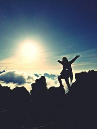 Silhouette of woman against sky