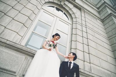 Low angle view of couple holding hands