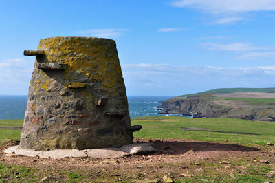 Old ruins by sea against sky