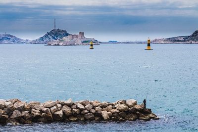 Panoramic view of sea and buildings against sky