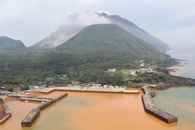 Aerial view of lake and mountains against sky