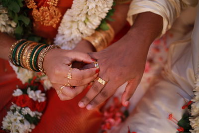 Midsection of couple holding hands