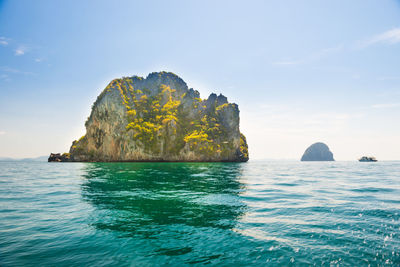 Scenic view of rock formation in sea against sky
