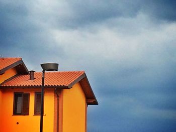 High section of building against cloudy sky