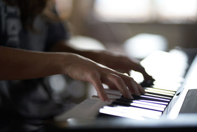 Cropped hand playing piano 