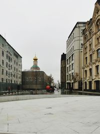 Buildings in city against clear sky