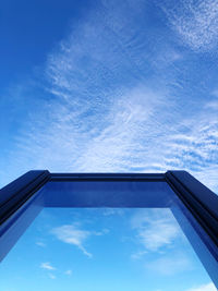 Low angle view of sky seen through glass window