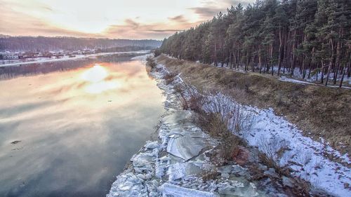 Scenic view of lake against sky during winter