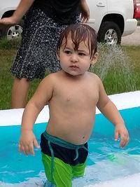 High angle view of shirtless boy in swimming pool