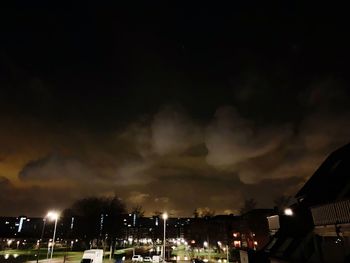 Illuminated city against sky at night