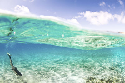 Woman snorkeling in sea against sky