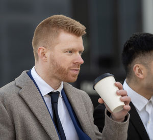 Side view of young man using mobile phone
