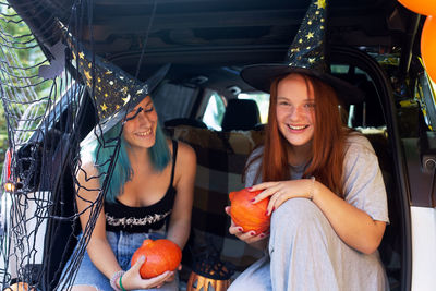 Young woman smiling while sitting in car