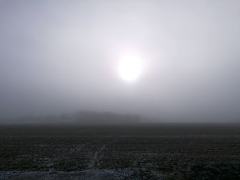 Scenic view of field against sky during winter