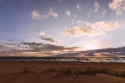 Scenic view of beach against sky during sunset