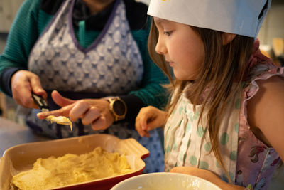 High angle view of girl learning to bake