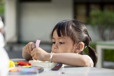 Close-up of cute girl with clay