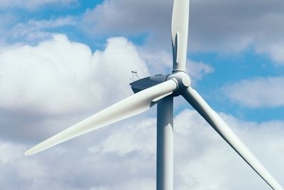 Low angle view of windmill against sky