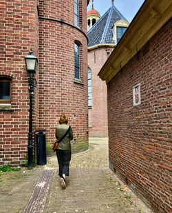 Rear view of woman walking on street