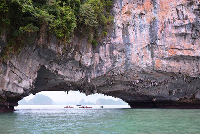 Tourists swim on a kayak boat in halong bay in northern vietnam. unique limestone islands in the sea