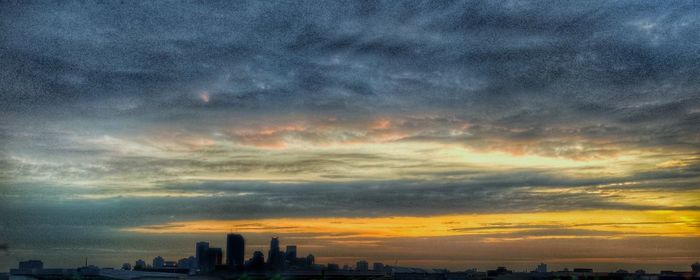 High section of cityscape against cloudy sky