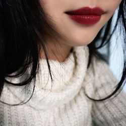 Midsection of young woman with red lipstick