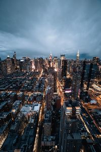 High angle view of illuminated city buildings against sky