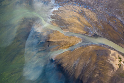 High angle view of water flowing through rocks