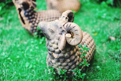 Close-up of animal sculpture on field