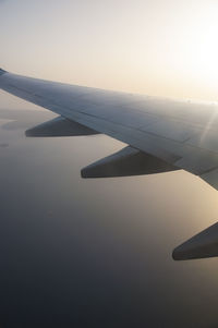 Airplane wing against clear sky