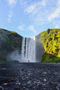 Scenic view of waterfall against sky