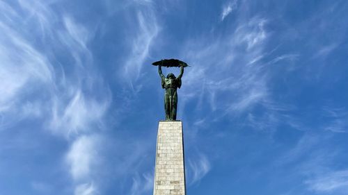 Low angle view of statue against cloudy sky