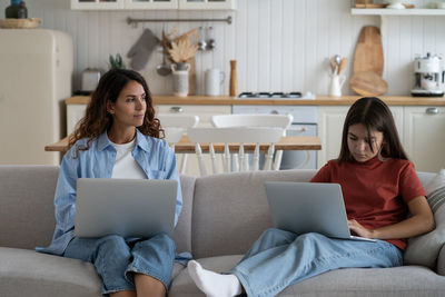 Young woman using laptop at home