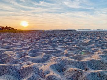 Scenic view of land against sky during sunset