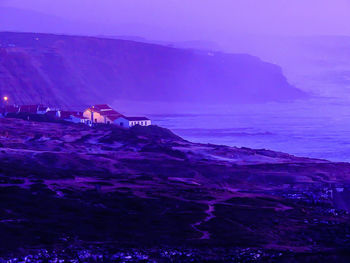 Scenic view of sea against sky at dusk