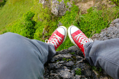 Low section of man standing on rock