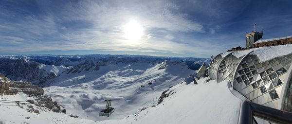 Scenic view of snow covered mountains against sky