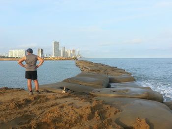 Full length of woman standing on beach