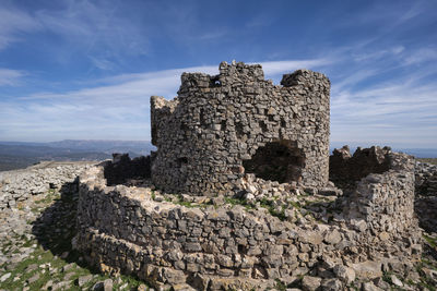 Old ruins of building against cloudy sky